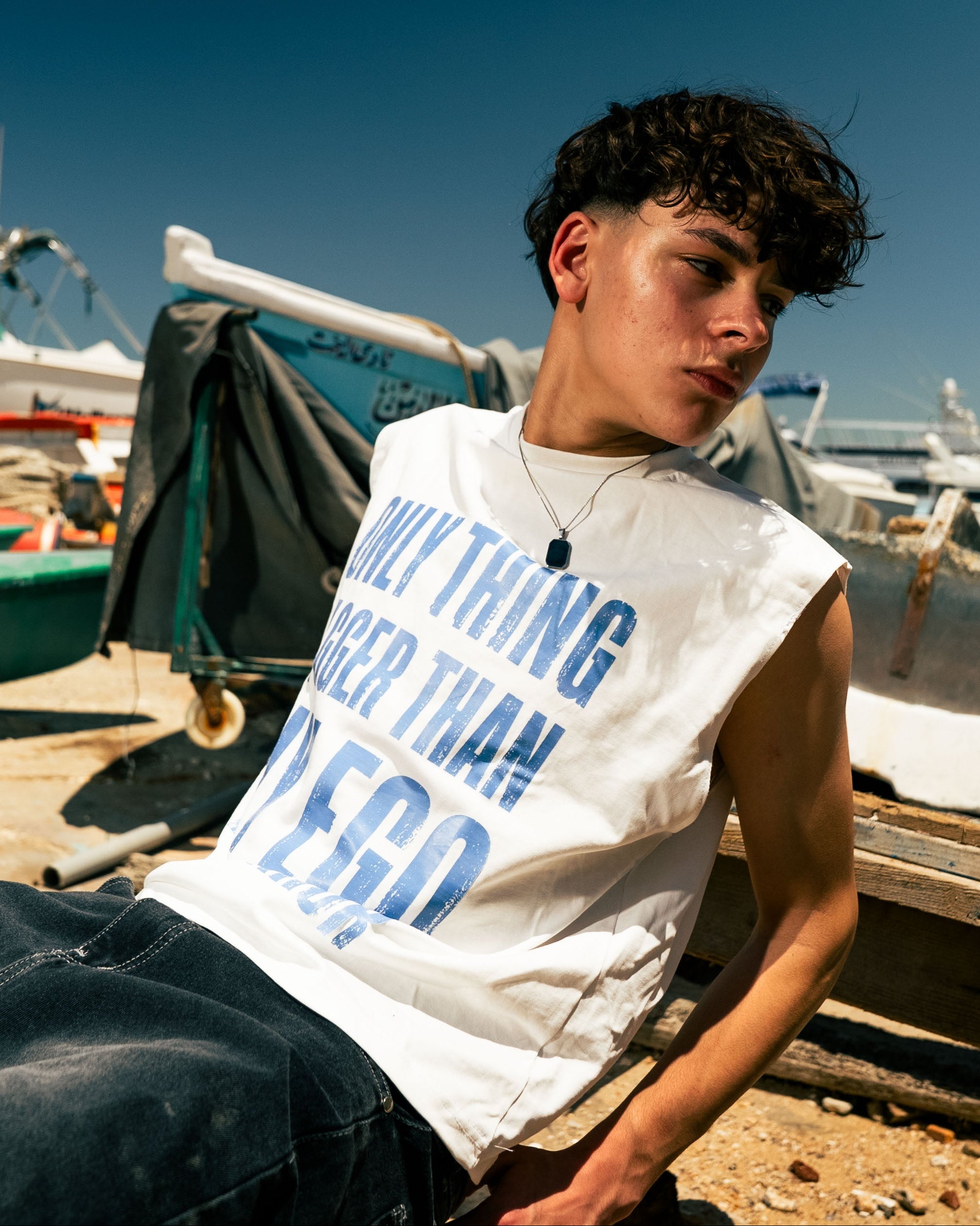 Person sitting on a boat with boats and water in the background