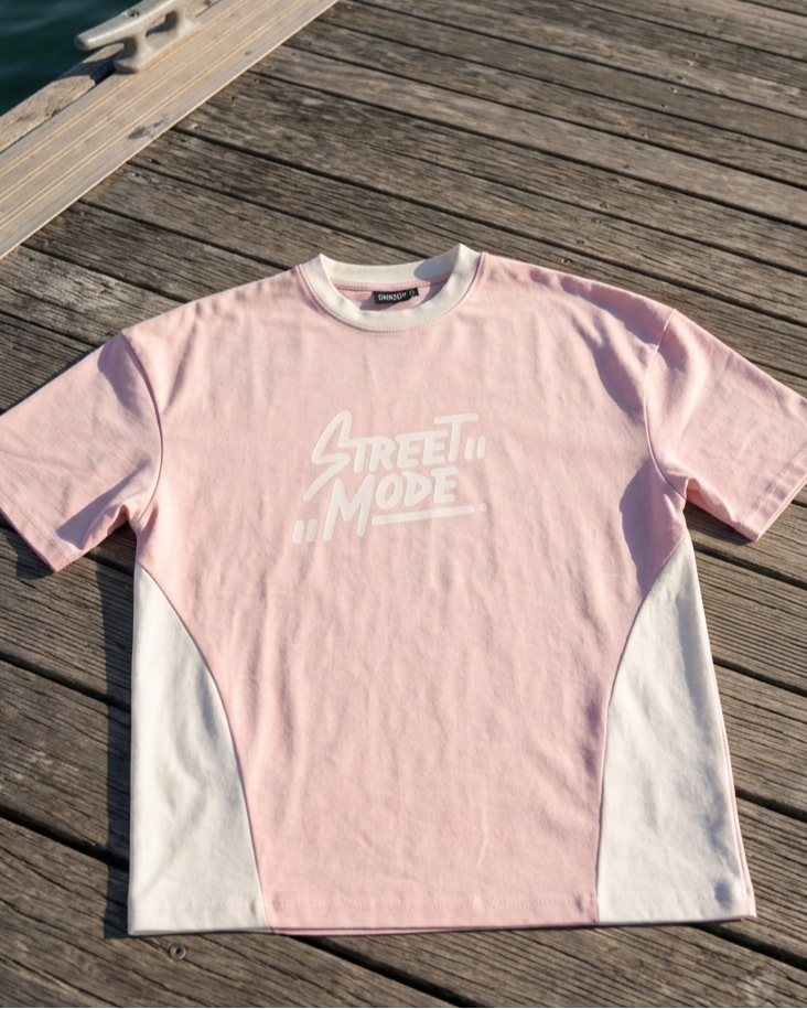 Pink t-shirt with 'Street Mode' text on a wooden dock by water