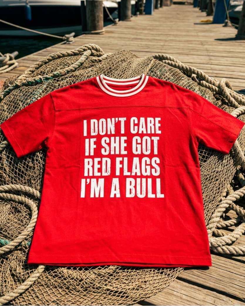 Red t-shirt with white text on a wooden dock background