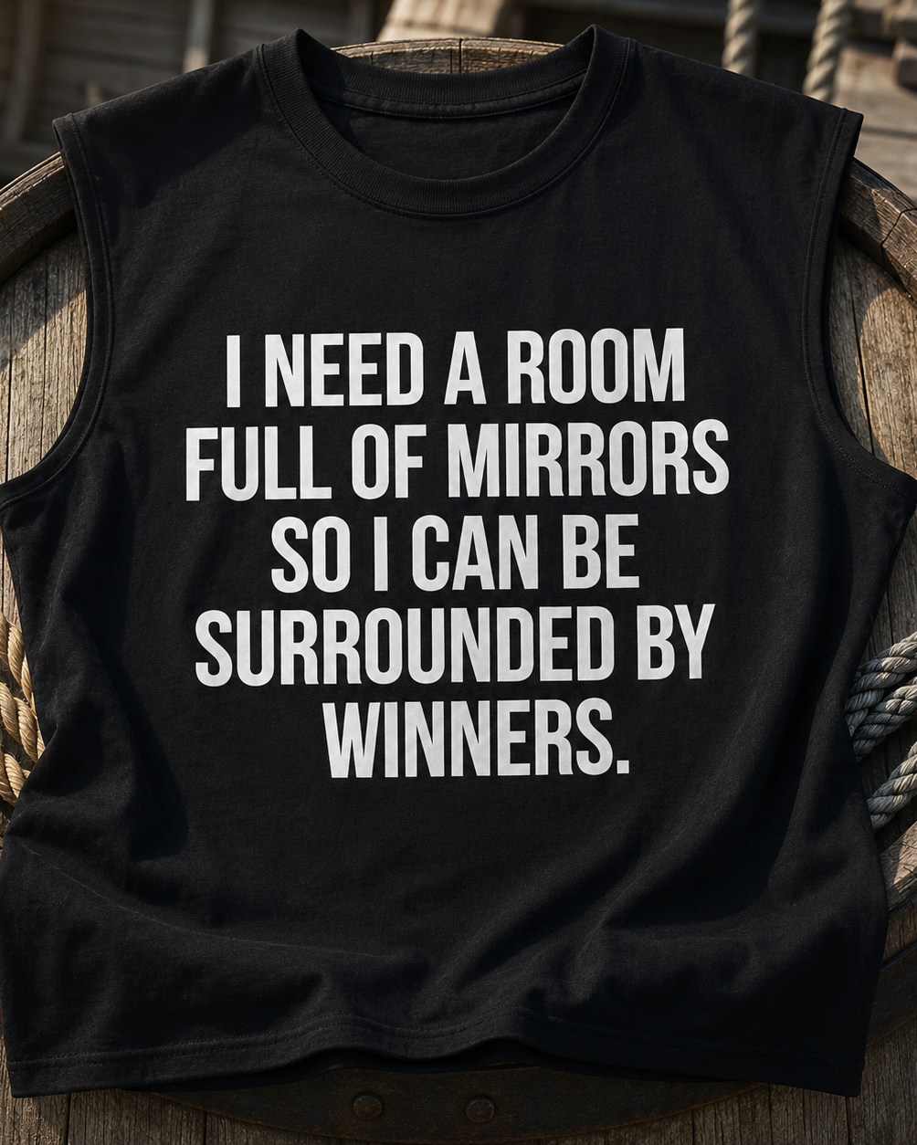 Black sleeveless shirt with motivational quote on a wooden barrel background